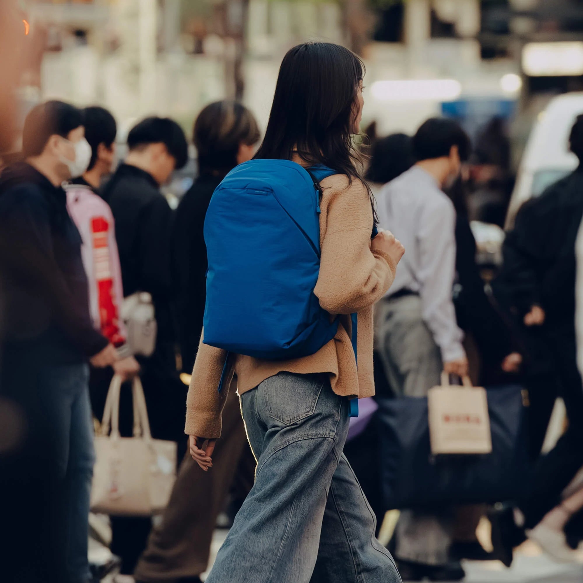 Woman carrying a Lapis color backpack image
